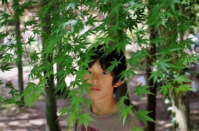 Portrait of boy looking at plants