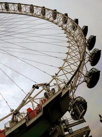 Low angle view of ferris wheel against sky