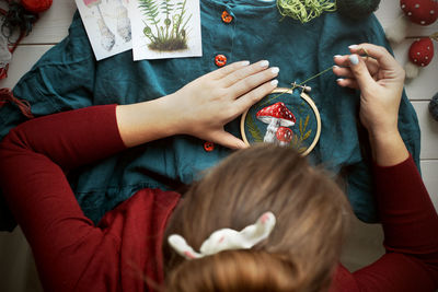 Flat lay with handmade fly agaric mushroom embroidery on dress