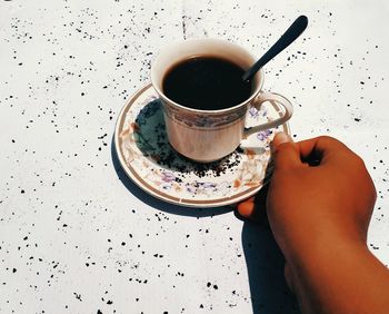 Woman holding coffee cup