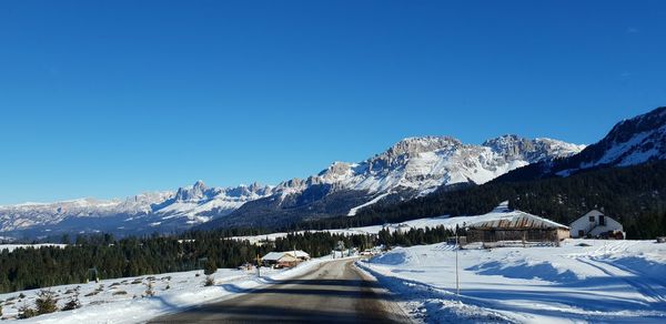 Scenic view of snowcapped mountains against clear blue sky