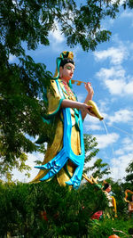 Low angle view of statue and tree at park