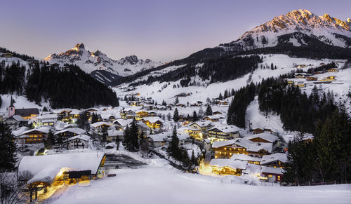 Snow covered houses against mountains