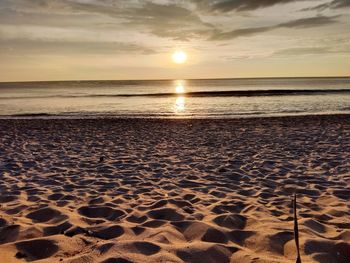 Scenic view of beach against sky during sunset
