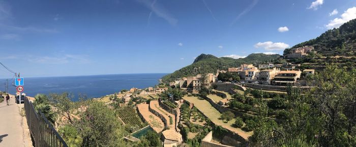 Panoramic view of sea and buildings against sky