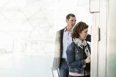 Business colleagues buying tickets at railroad station