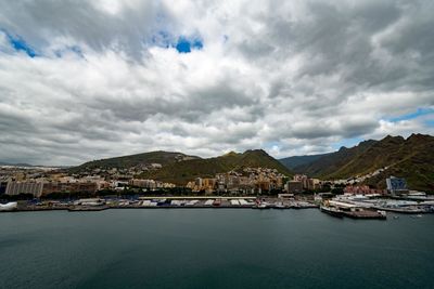 Scenic view of sea by buildings against sky