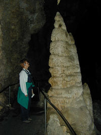 Rear view of young woman standing at night