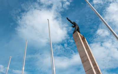 Low angle view of statue against cloudy sky