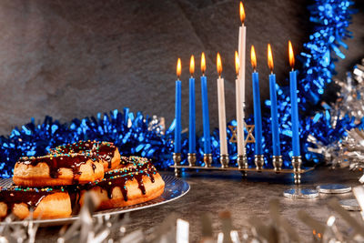 High angle view of illuminated candles on table
