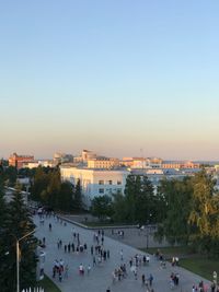 High angle view of people in city against sky during sunset