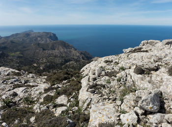 Scenic view of mountains and sea against sky