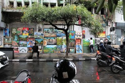 People on wet street in city during rainy season