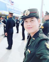 Portrait of smiling woman in uniform standing outdoors