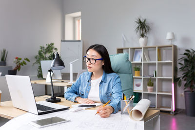 Young woman using laptop at office