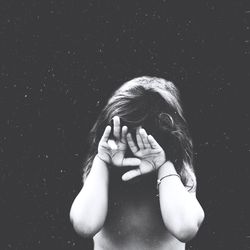 Shirtless girl covering face with hands
