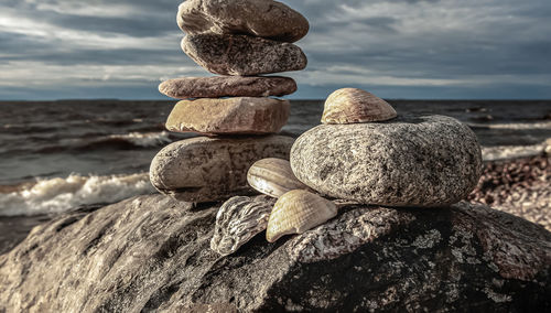 Close-up of stone stack on shore