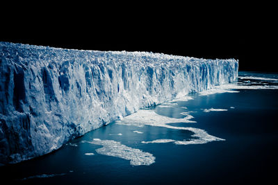 Scenic view of frozen sea at night