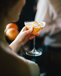 Midsection of woman holding drink