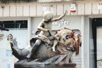 Lion statue against building