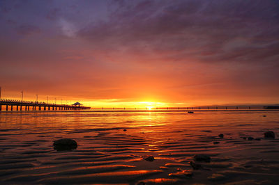 Scenic view of sea against romantic sky at sunset