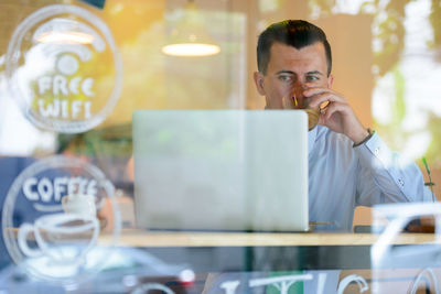 Portrait of young man using mobile phone