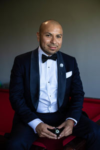 Portrait of groom against white background