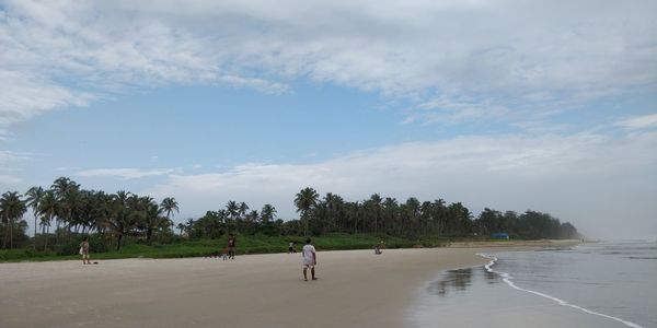 People on beach against sky