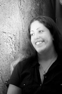 Portrait of a smiling young woman against wall