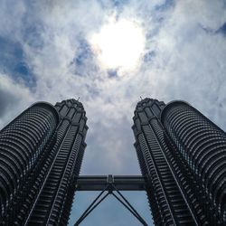 Low angle view of modern building against cloudy sky