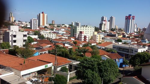 High angle view of buildings in city against clear sky