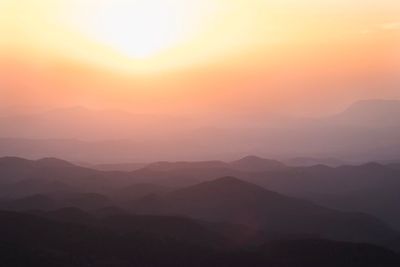 Scenic view of silhouette mountains against sky at sunset