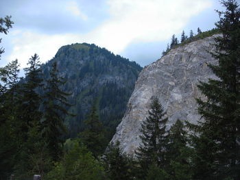 Low angle view of mountains against cloudy sky