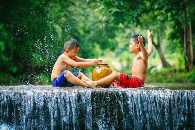 Boy sitting in water