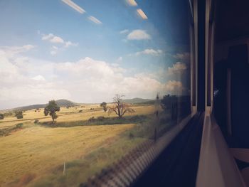 Panoramic view of landscape seen through train window