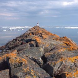 Scenic view of sea against cloudy sky