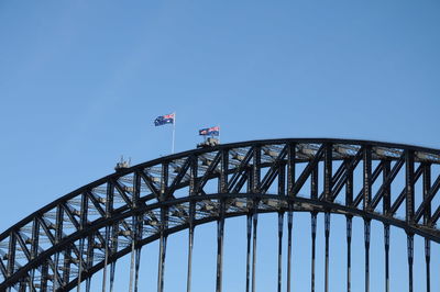 Low angle view of flag against clear blue sky