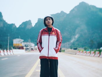 Portrait of teenage girl standing on mountain road