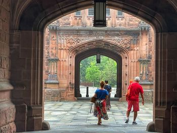 Rear view of people walking in building