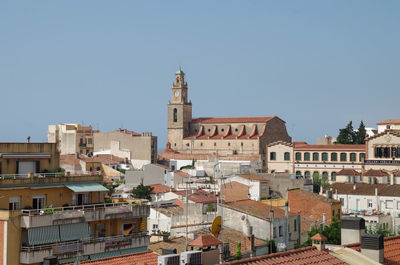 Buildings in town against clear sky