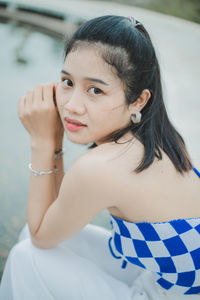 Portrait of young woman looking away