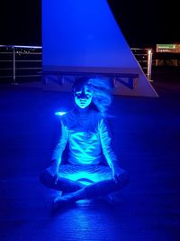 Young woman in illuminated light painting at night