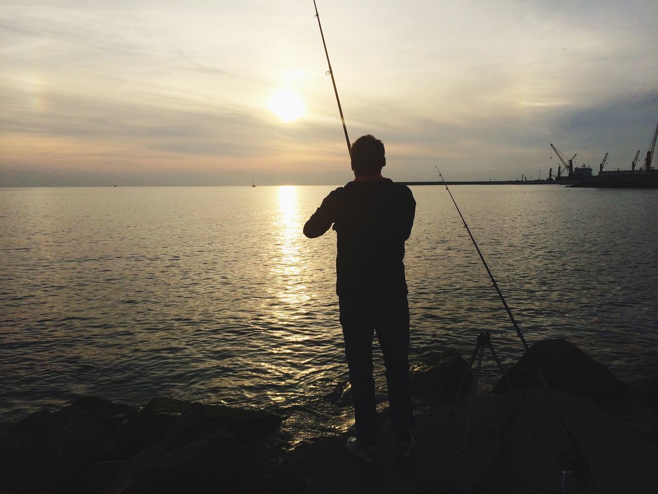 sunset, water, silhouette, sky, sea, sun, lifestyles, leisure activity, standing, reflection, men, scenics, tranquility, fishing rod, beauty in nature, tranquil scene, cloud - sky, nature