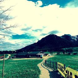 Scenic view of mountains against cloudy sky