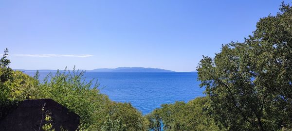 Scenic view of sea against blue sky