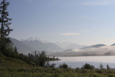 Scenic view of lake and mountains against sky