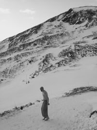 Full length of man standing on sand against sky