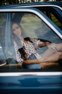 Reflection of woman in car window