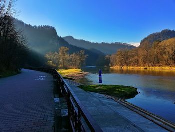 Scenic view of lake against clear blue sky