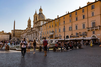 Group of people walking on street in city
